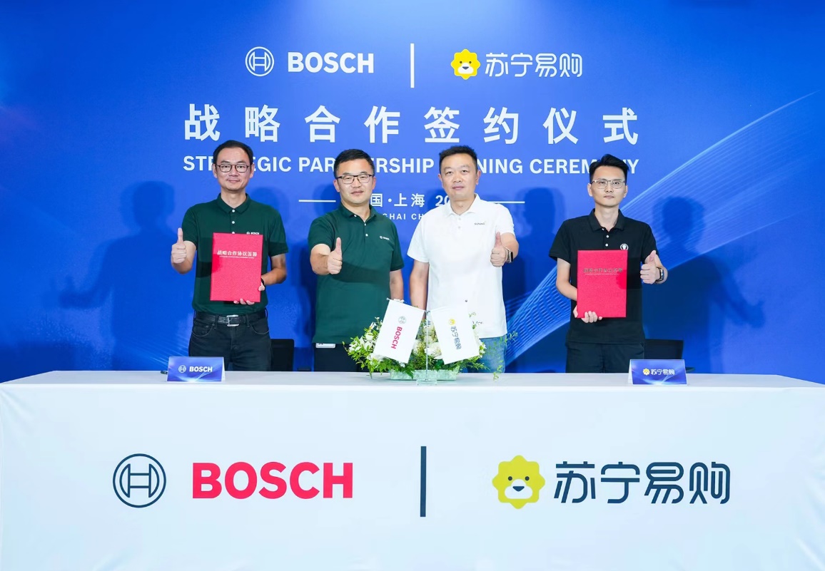 A group of men standing in front of a blue background
Description automatically generated